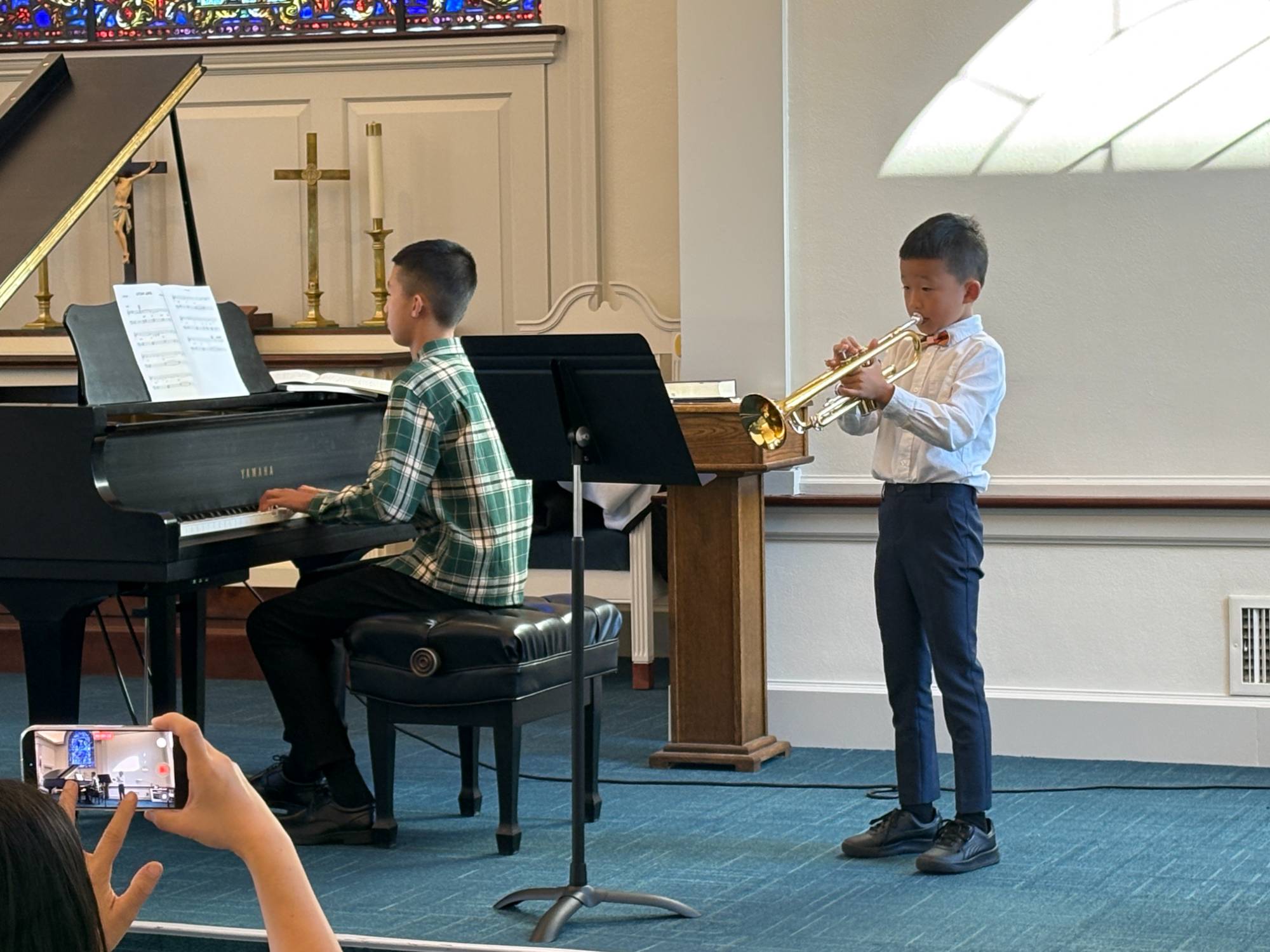Trumpet and piano duet performing a song